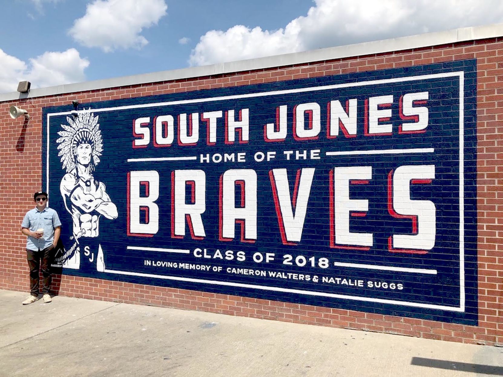River Prince with one of the signs he’s proudest of — the one at his alma mater. (Facebook).jpeg